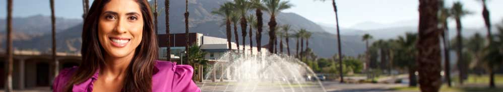 Faculty member standing near fountain